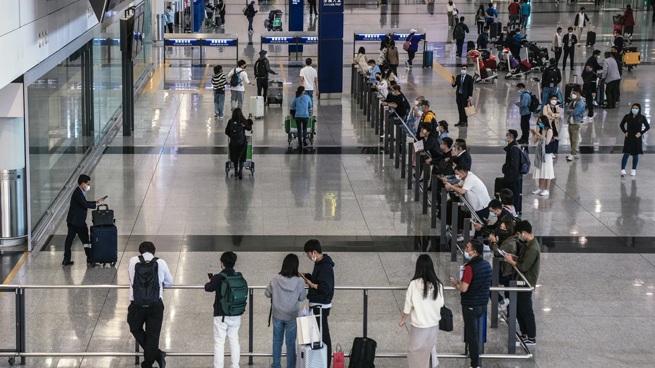 Passengers arrive at Hong Kong International Airport on February 17, 2023.